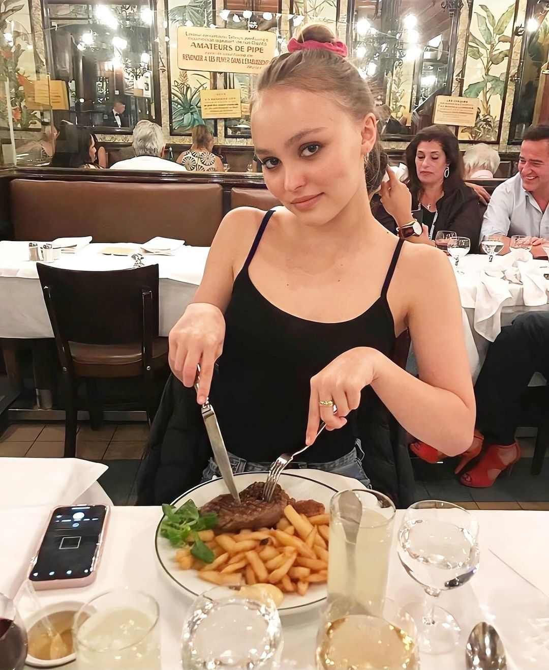 Lily-Rose Depp eating meat and fries