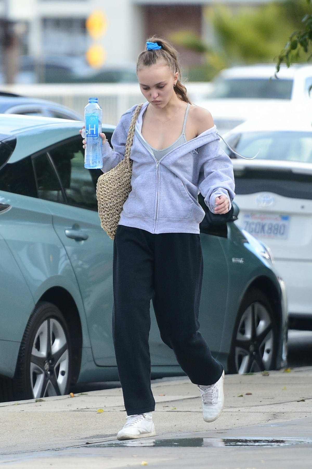 Lily-Rose Depp holding a bottle of water