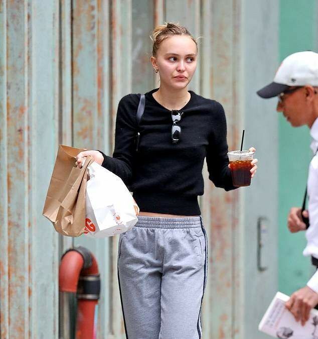 Lily-Rose Depp holding coffee